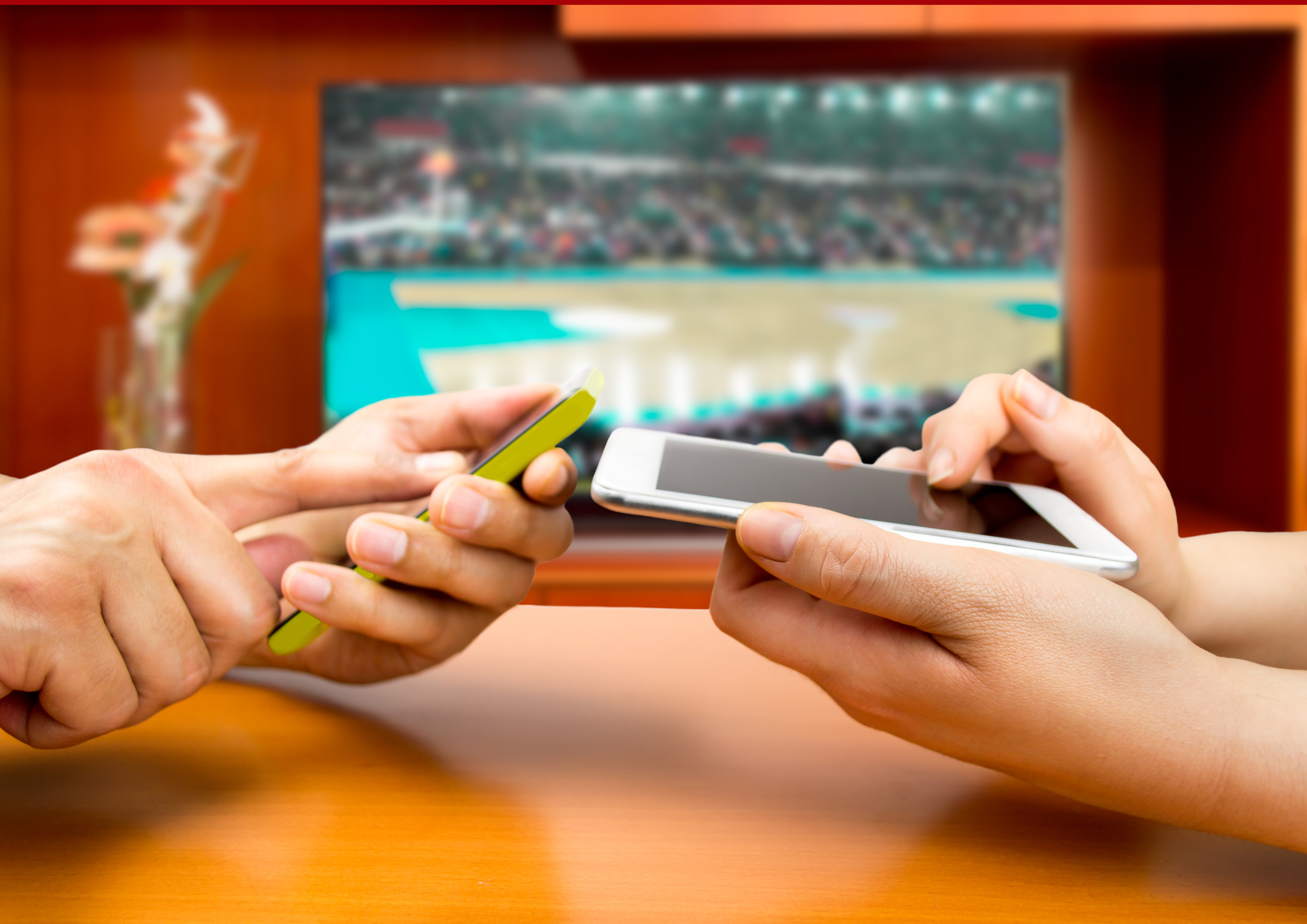 Friends using mobile phone and betting during a basketball match.With a tv background and an image of a basketball match